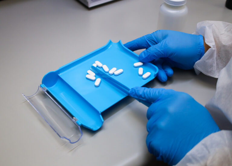 Nutraceutical Contract Packaging and Sample Fulfillment 1 White supplement tablets counted on a blue counting tray before pouch filling at Supera Fulfillment